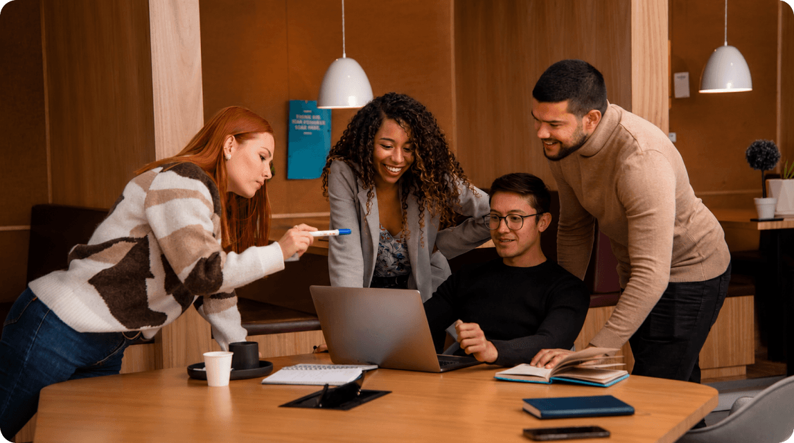 Nexovea team collaborating around a laptop